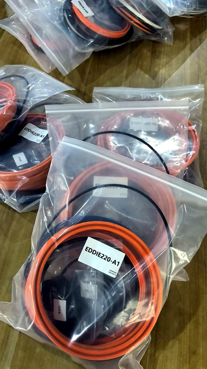 Several hydraulic breaker seal kits in sealed bags on the bench, EDDIE220-A1 in front