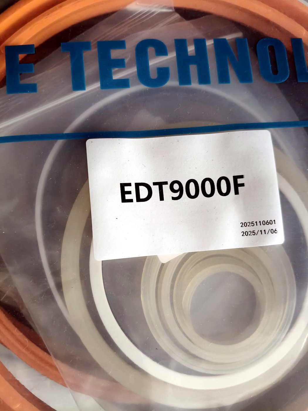 Close-up of a kit label showing the model EDT9000F and batch code, PTFE rings visible inside the bag